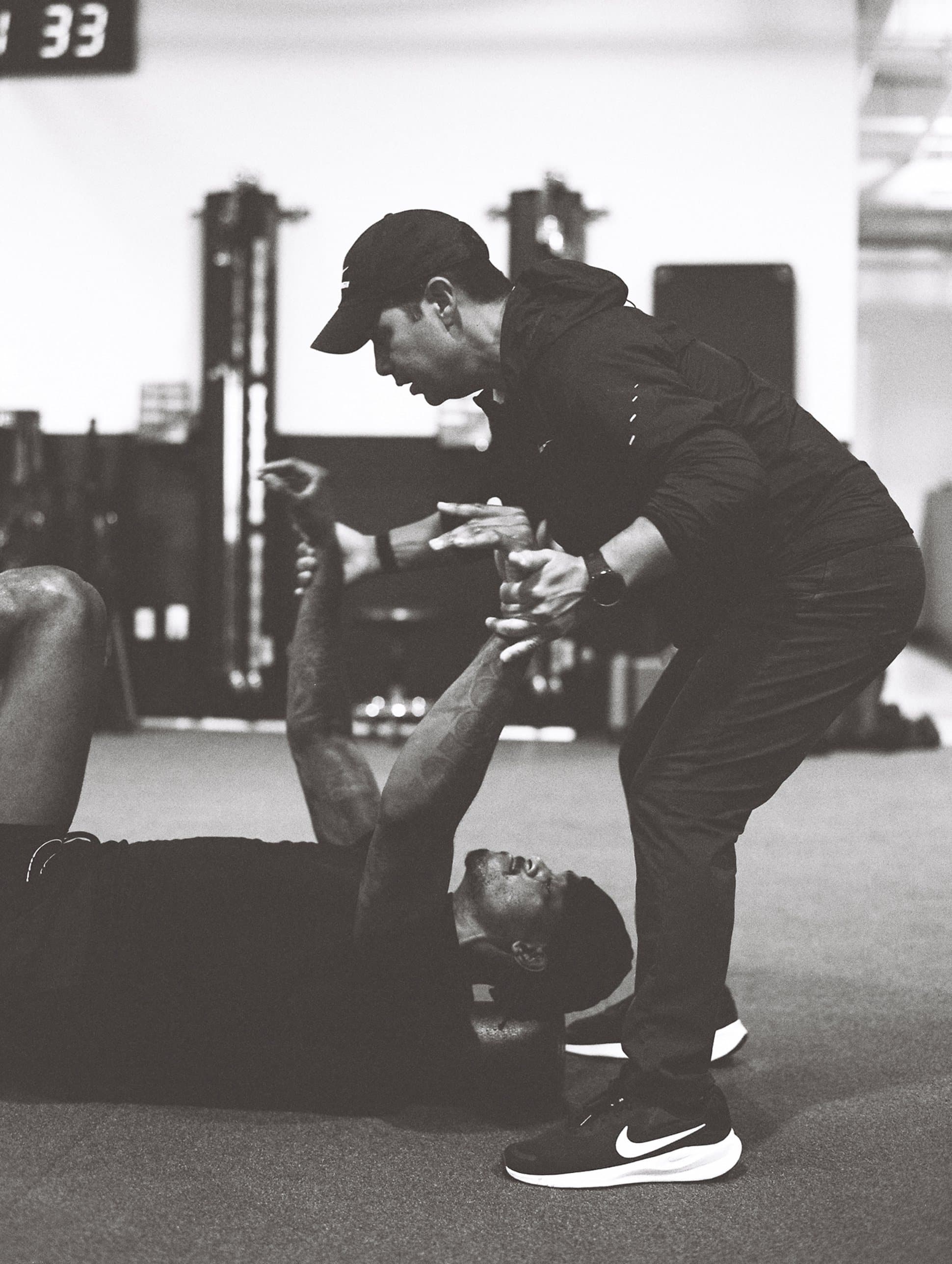 Mike Mancias working with an athlete on the gym floor